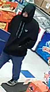 Person wearing a black hoodie and dark pants