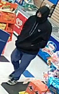 Person wearing a black hoodie and dark pants