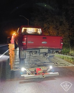 Red Ford Ranger on a flatbed tow truck.