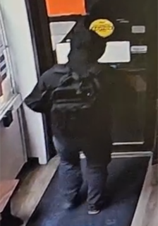 Person wearing a black hoodie and jeans