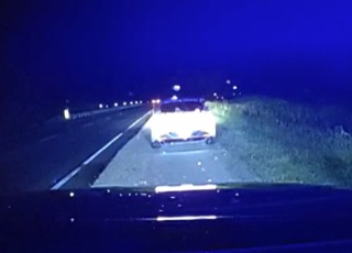 Police car with flashing lights on a dark road
