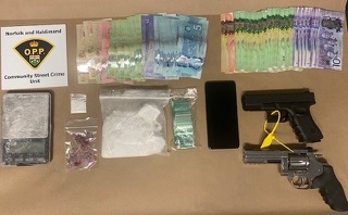 Canadian currency and baggies of white powder, a black smartphone, and a toy handgun.
