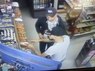 Two people in a store aisle.