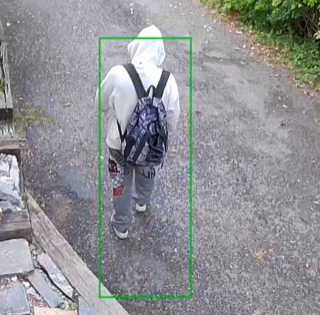 Person walking away, carrying a backpack