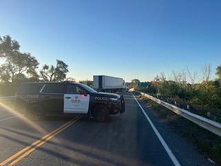 Police SUV and semi-truck on highway