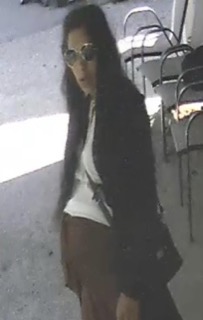 Person with long dark hair and sunglasses.