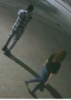 Two people walking away from the camera.