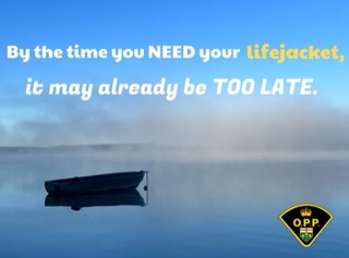 Boat on calm water. Text: By the time you NEED your lifejacket, it may be too late.