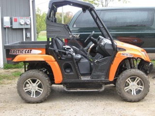Orange Arctic Cat side-by-side ATV