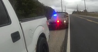 White pickup truck, police car with flashing lights