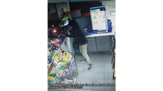 Person walking past shelves of snacks