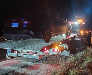 Black SUV on a car trailer.