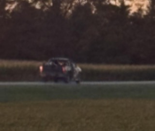 Dark car driving on a road