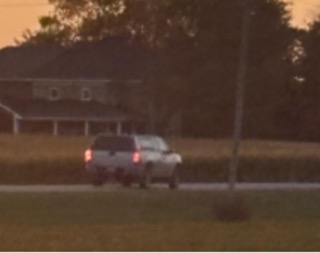 Pickup truck driving on a road at dusk