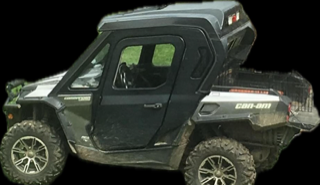 Mud-covered Can-Am side-by-side vehicle