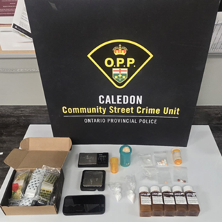 O.P.P. crest and text: CALEDON Community Street Crime Unit, Ontario Provincial Police. Items on a white surface include a partially open box, small baggies, a digital scale, a vape pen, and several bottles.