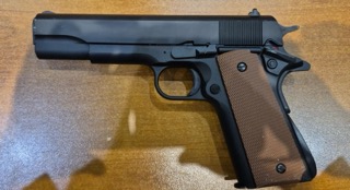 Black 1911 pistol with wood grips