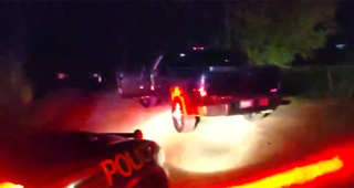 Police car with flashing red and blue lights.