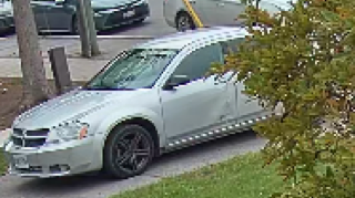 Silver sedan parked on a street.
