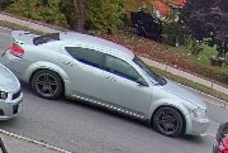 Silver sedan parked on a street.