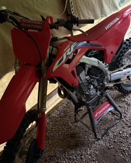 Red dirt bike on a stand.
