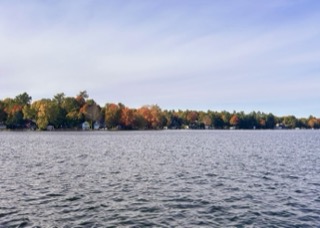 Calm lake with colorful trees along the shoreline