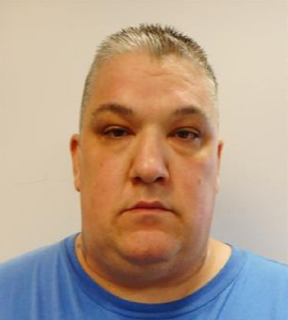 Man with short graying hair, blue t-shirt