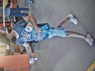 Person mid-air, wearing blue shorts and white sneakers