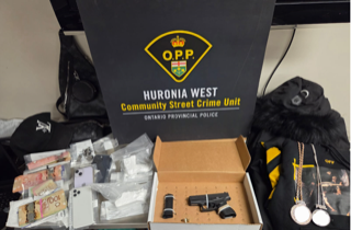 Money, drugs, and firearms on a table.