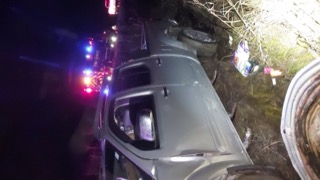 Damaged vehicle with emergency lights.