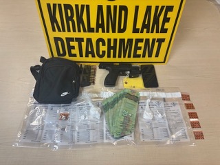 Black Nike bag, two handguns, bundles of cash, small baggies.