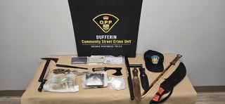 O.P.P. and Dufferin Community Street Crime Unit logos visible. Assorted weapons and items on a table.