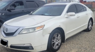 White sedan with visible damage