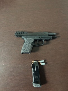 Black handgun and magazine with ammunition.