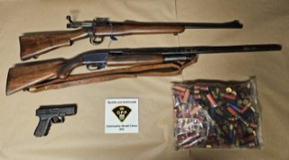 Two long guns and a handgun with ammunition.