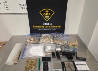 Drugs in clear plastic bags, handgun, ammunition, police evidence markers