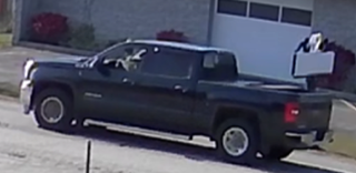 Black pickup truck parked on pavement