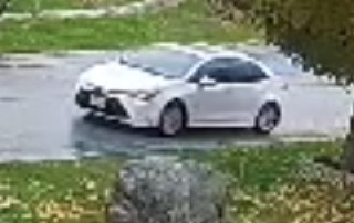 White sedan on wet pavement