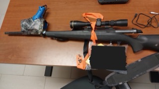 Rifle with scope and orange strap