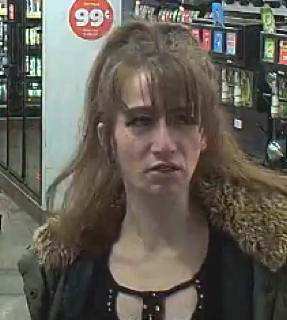 Person with dark hair and bangs, looking downwards