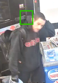 Person in a black hoodie and backpack.