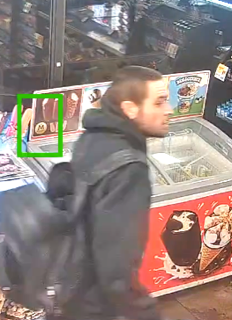 Person walking past a freezer full of ice cream