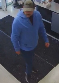 Person wearing a blue hoodie and dark pants