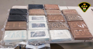 Stacked packages of suspected drugs, wrapped in plastic.