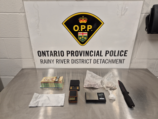 Canadian currency and packages of a white substance, digital scales, knife.