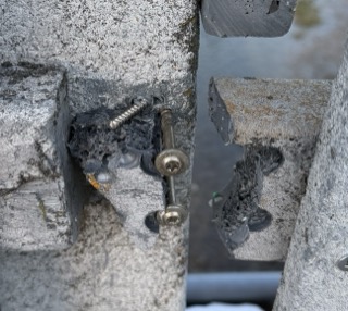 Close-up of a weathered metal latch and bolt.