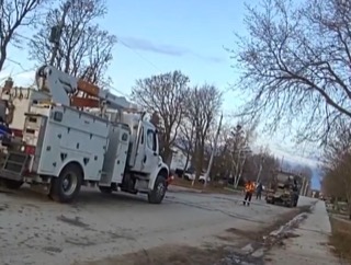Utility truck and worker on a residential street