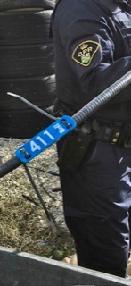 Police officer in uniform, 411 visible on arm badge