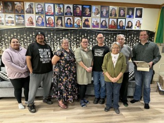 Group of people standing, smiling.