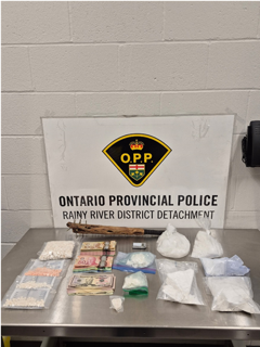 Ontario Provincial Police, Rainy River District Detachment logo. Packages of suspected drugs and Canadian currency on a metal surface.
